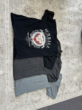 Set of three O’Neill Men’s Medium t-shirts. One black, two gray colored.